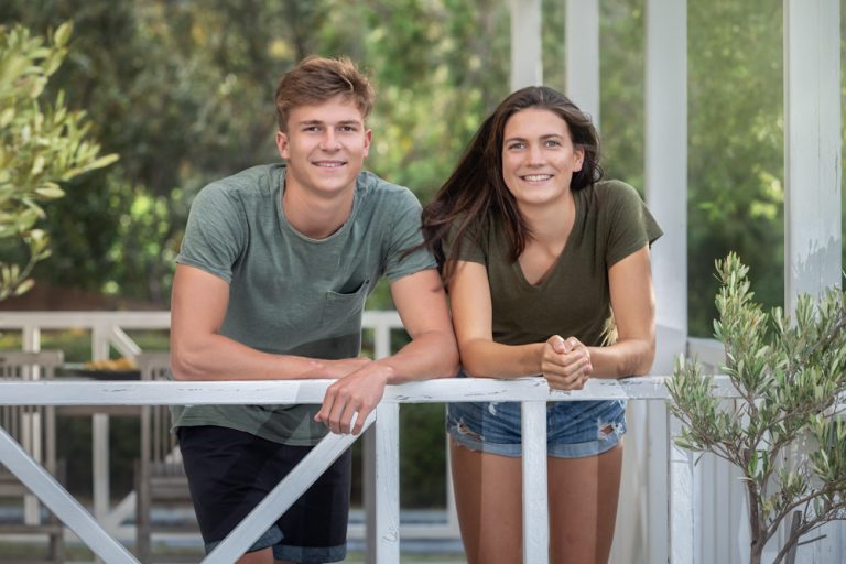 lifestyle portrait of brother and sister leaning over balcony by katja photography