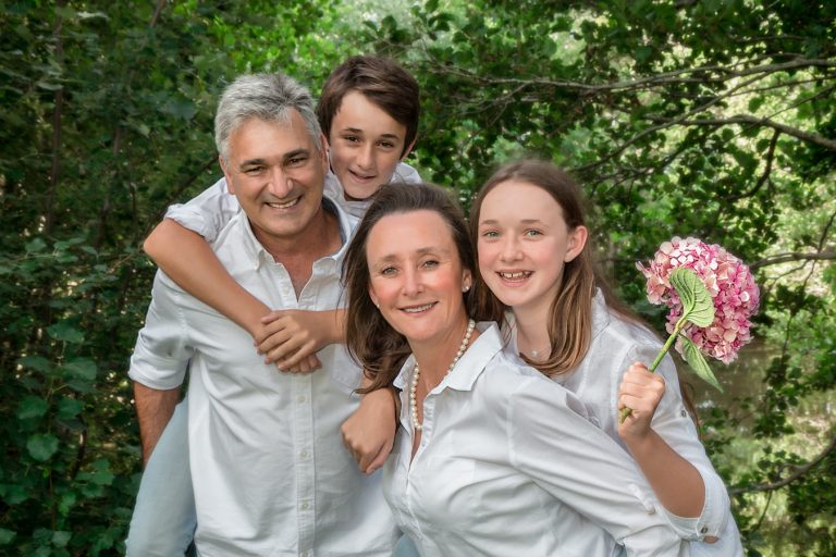 lifestyle portrait of family dressed in white and smiling by katja photography