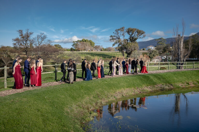 Portrait of a group of teens dressed in evening wear for their matric dance walking around a lake by Katja Photography