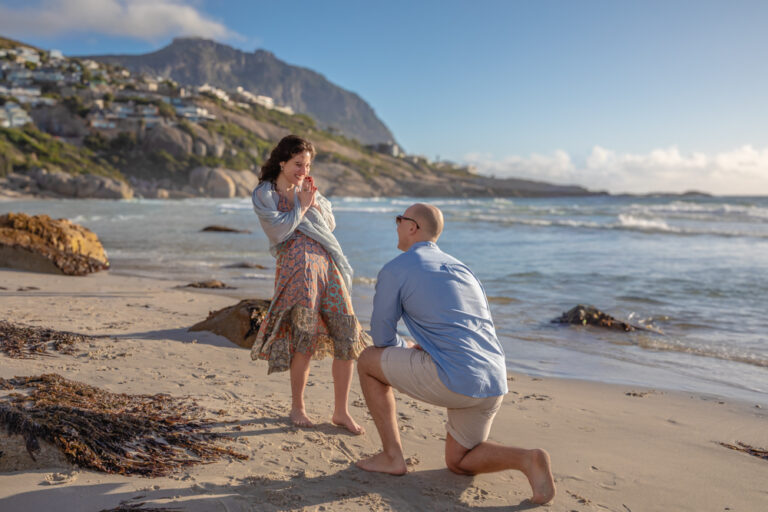 Man proposing to his girlfriend on the beach by Katja Photography