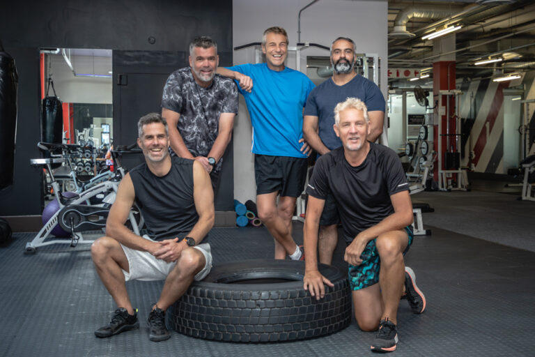 Portrait of five senior men posing at a gym by Katja Photography